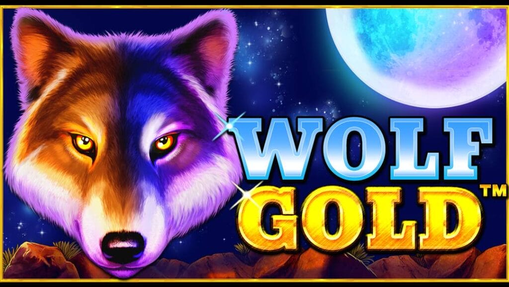 The Wolf Gold slot banner. The backdrop is a beautiful night sky with a full moon above a rocky American desert. In the foreground is a wolf’s face and the title “Wolf Gold.”
