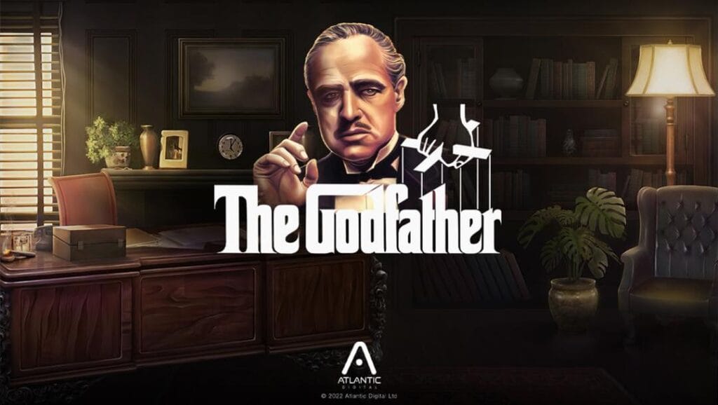 The Godfather slot machine banner. The background is a digitally rendered painting of The Godfather’s office. His desk is to the left. A window behind it lets light into the room. To the right is an armchair with a lamp behind it. In the foreground is the game title in the classic The Godfather font. A portrait of the Godfather is visible above the title.